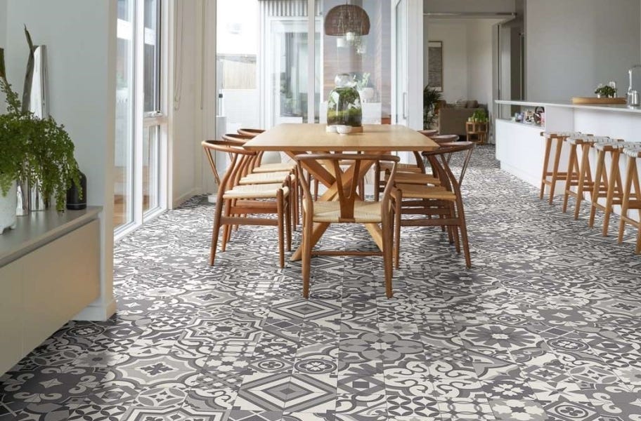 Patterned gray and white tile look vinyl sheet flooring underneath dining room table