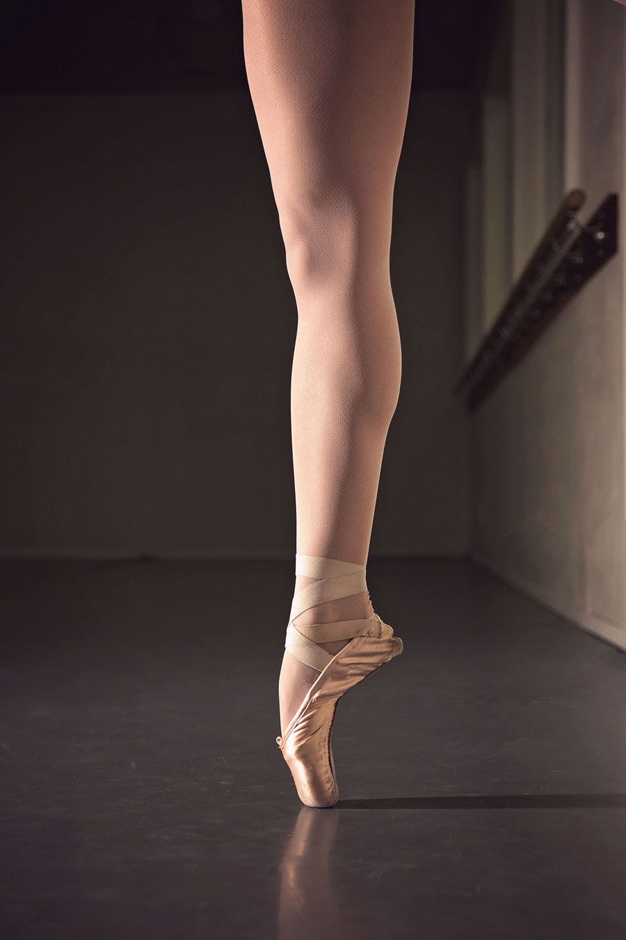 A ballet dancer up on her toes on a dance floor