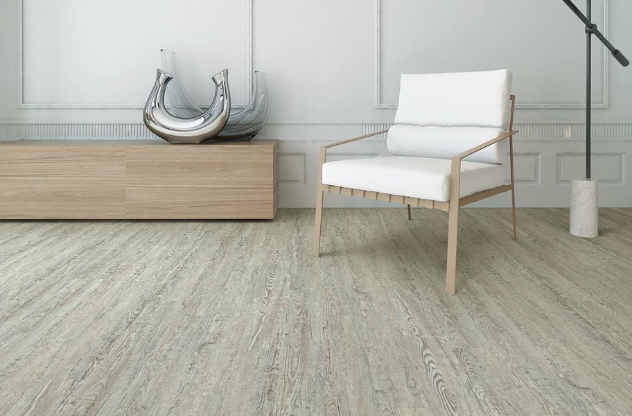 SPC vs. WPC: Gray wood-look SPC vinyl flooring in a living room setting.