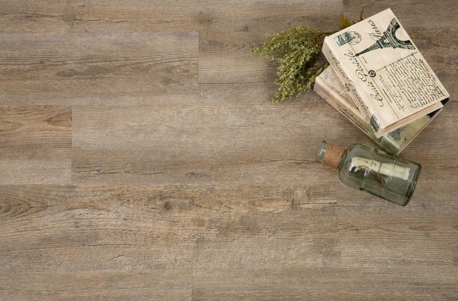vinyl plank flooring with books, herbs, and a glass bottle