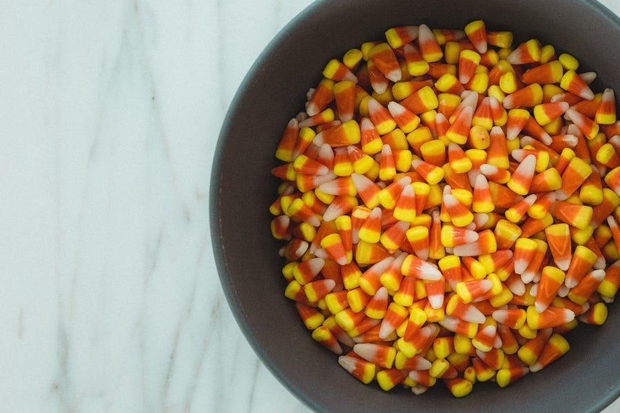 Halloween garage trick-or-treating area with bowl of candy corn