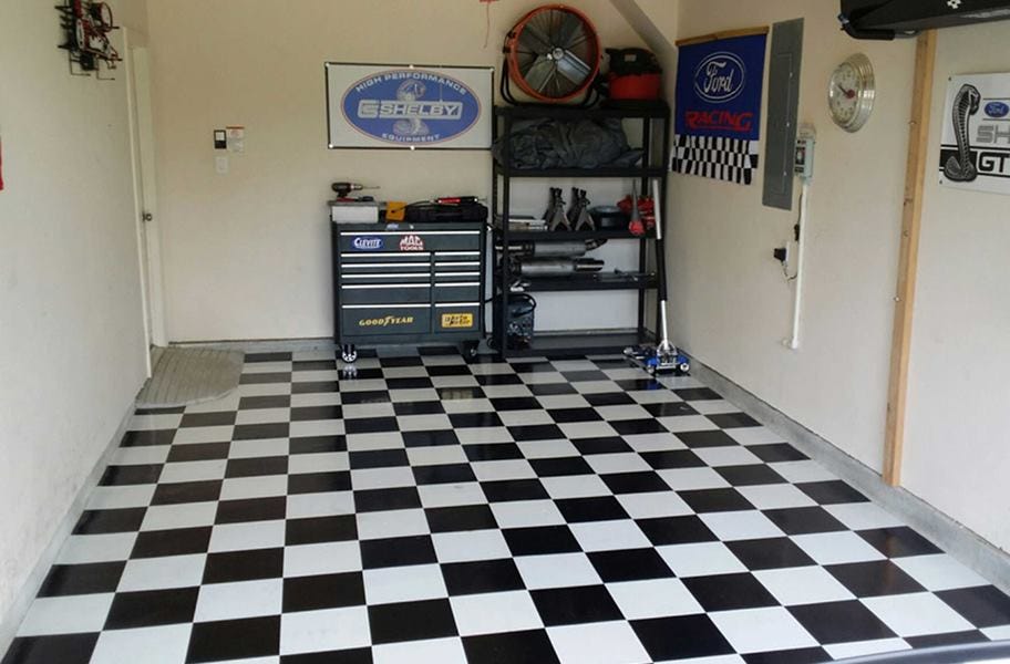 Black and white checkered peel & stick vinyl floor tiles in garage
