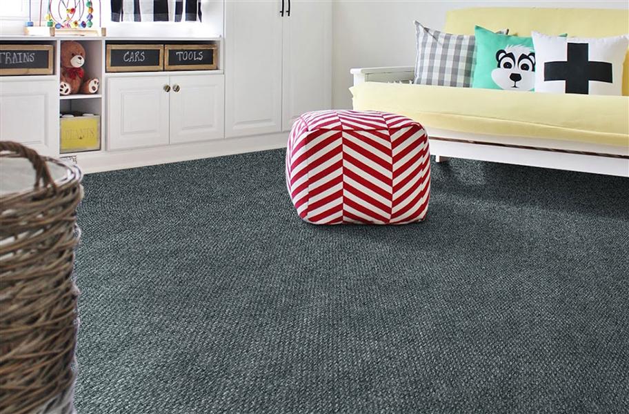 blue-gray carpet in living room with yellow couch and striped puff