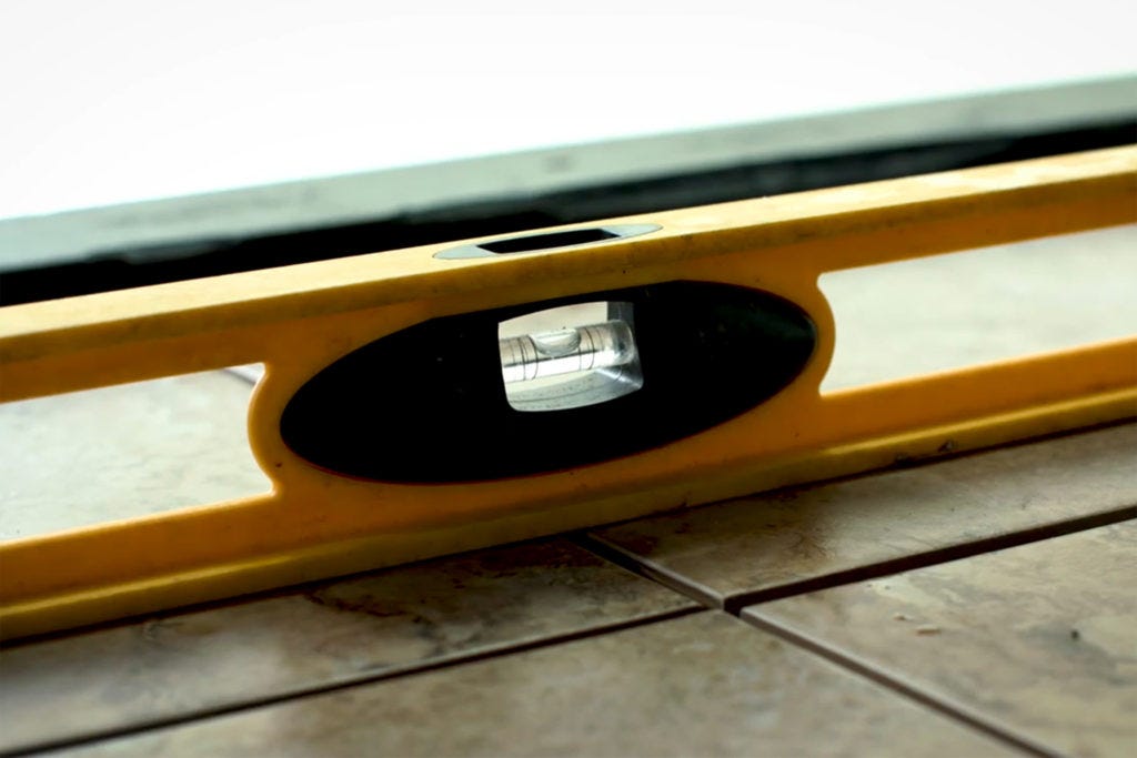 Bubble level measuring the tile surface