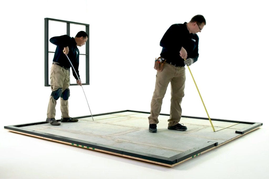 Installation professionals measuring a room for tile