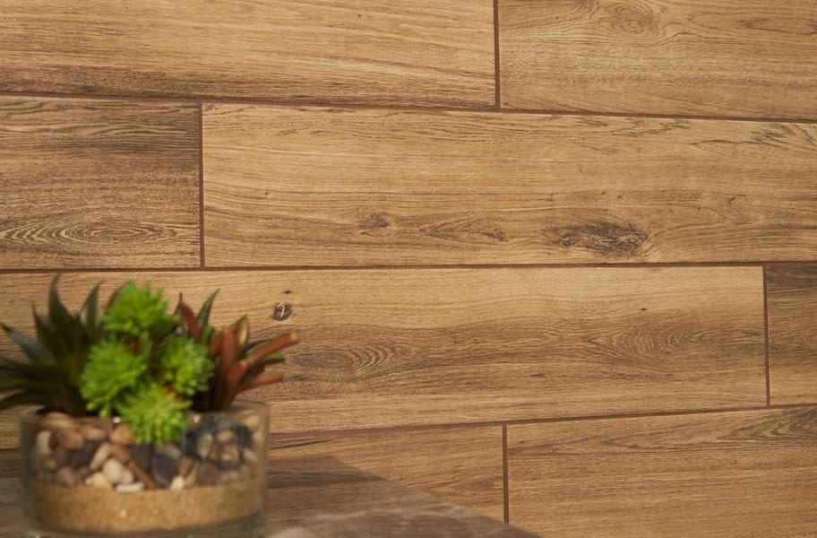 Brown grout between wood-look wall tiles.