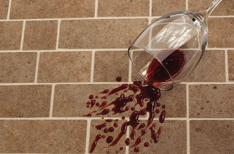 Sealed grout resisting a wine stain.