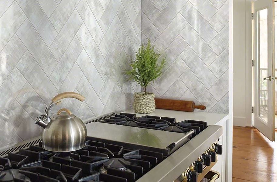 Subway tiles in a herringbone pattern in a kitchen backsplash