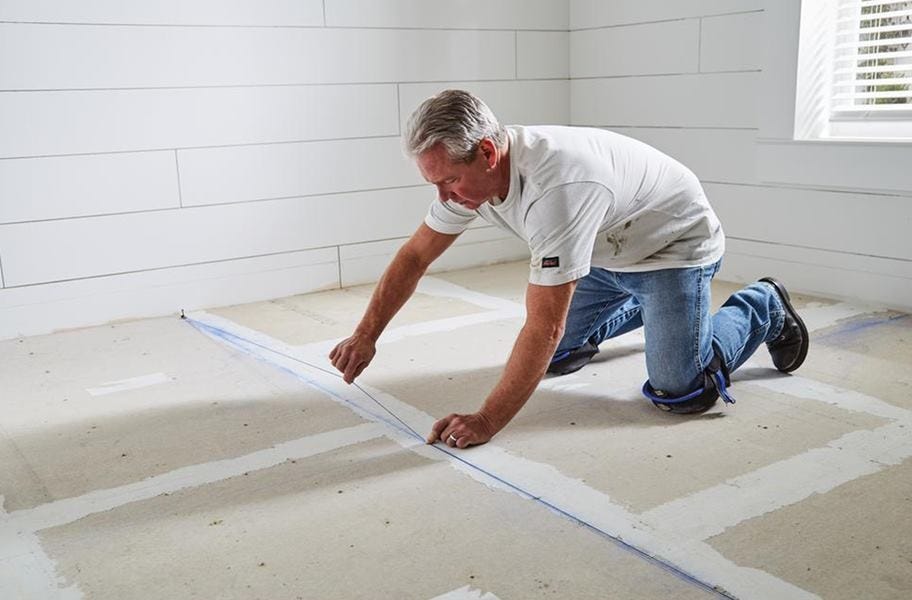 Man prepping the subfloor for installation wearing Stabilizer Knee Pads