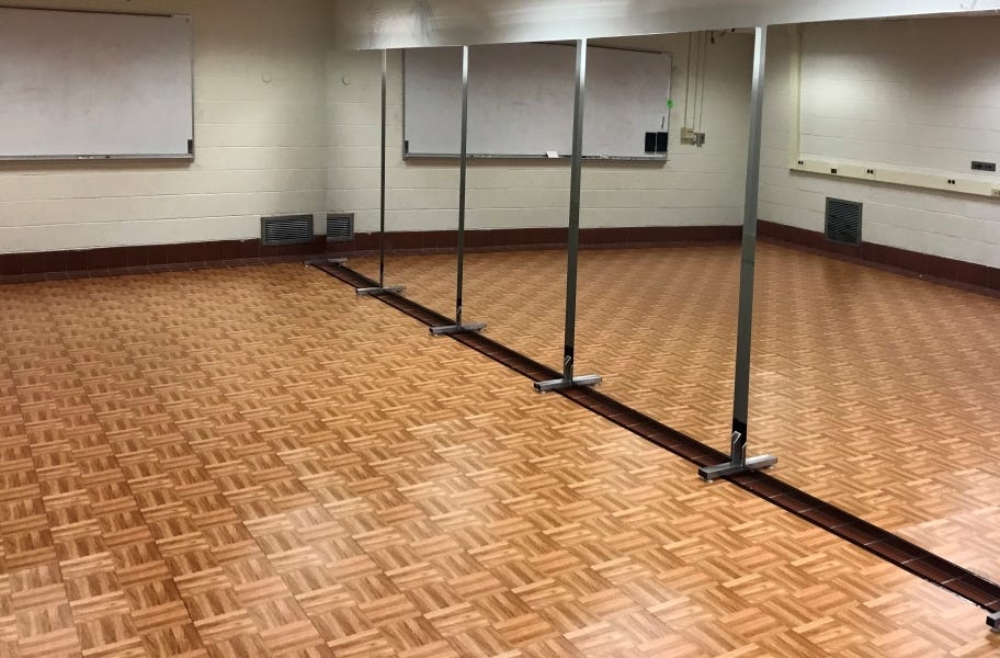 dance floor tiles in a dance studio in front of a wall of mirrors