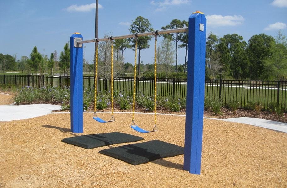 Swing set with two Safety Swing Mats underneath for added cushion and softer landing after children swing and play. 