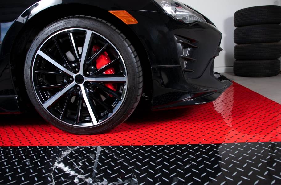 Black car sitting on top Nitro Tiles Pro surface - great garage floor idea for gift giving