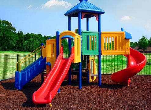 Playground equipment with mulch rubber flooring